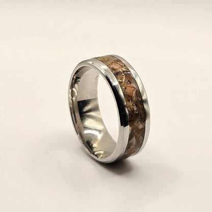 Silver ring on a light gray background