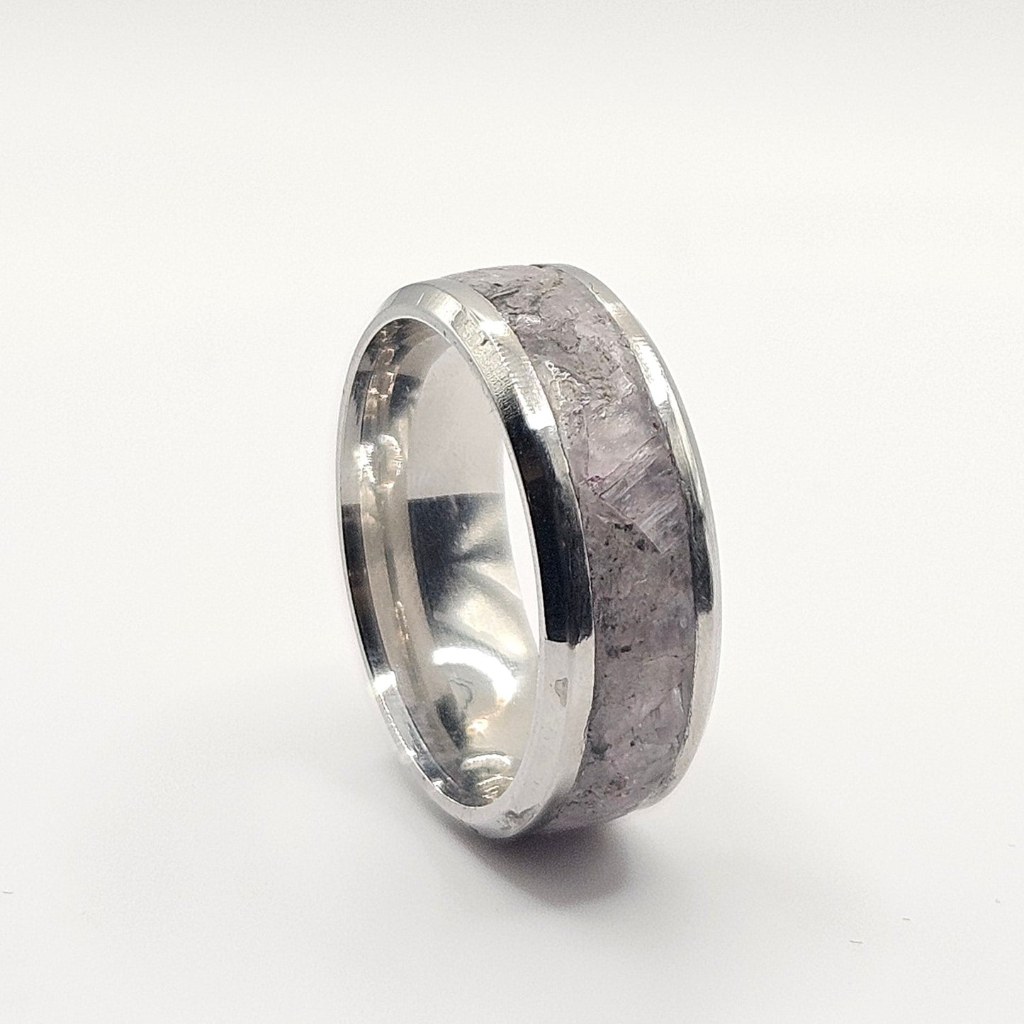 Silver ring with a textured surface on a white background