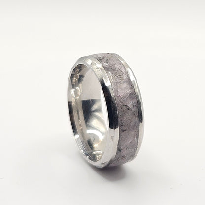 Silver ring with a textured surface on a white background
