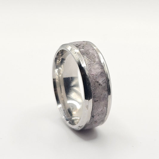 Silver ring with a textured surface on a white background
