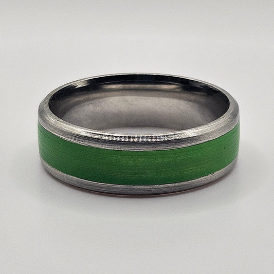 Green ring with metallic band on a white background