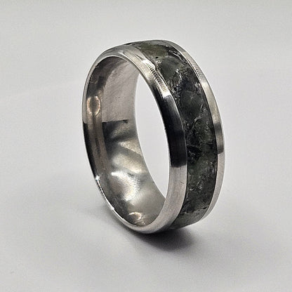 Silver ring with a textured band on a light gray background
