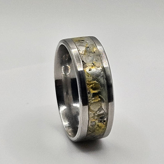 Silver ring with embedded stones on a light gray background